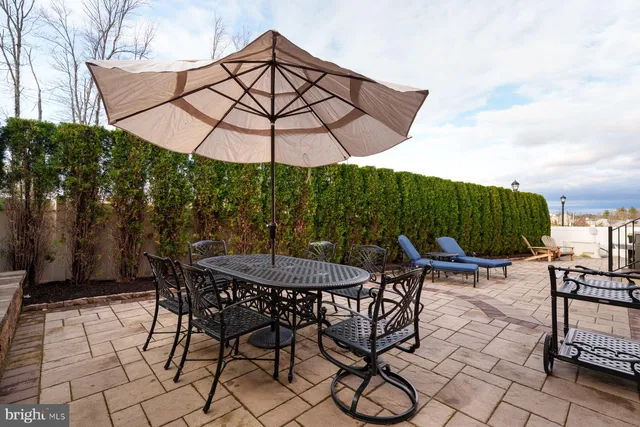 a patio with a patio table and chairs