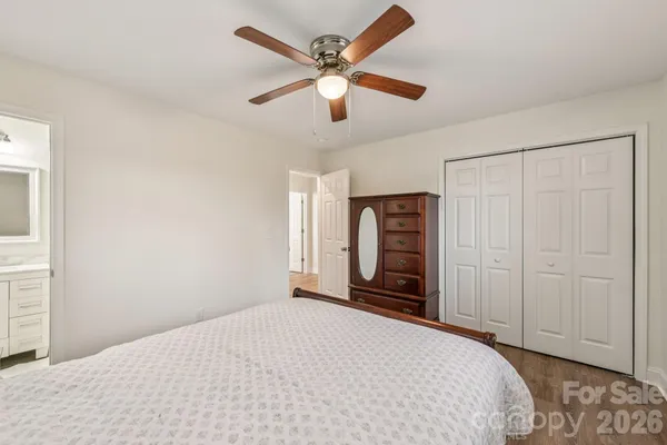 a bedroom with a bed and a ceiling fan