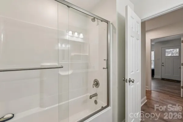 a bathroom with a glass shower door