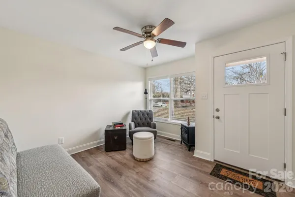 a room with wooden floor and white walls