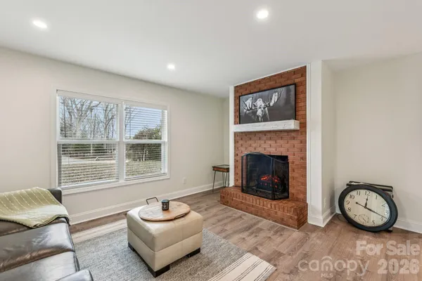 a living room with furniture a window and a fireplace