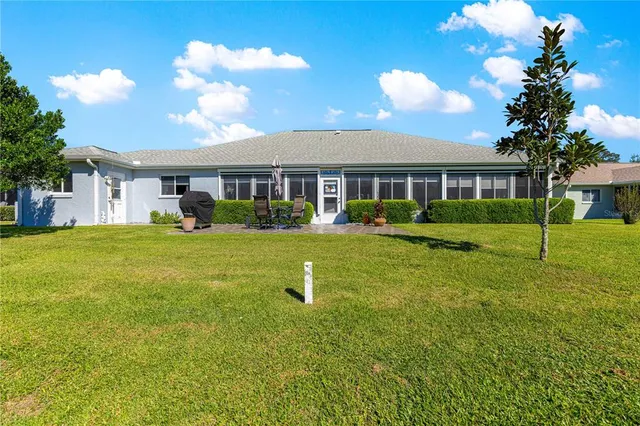 a view of a house with yard and lake view