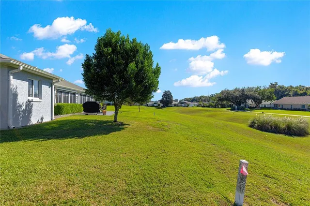 a view of a house with a big yard and potted plants