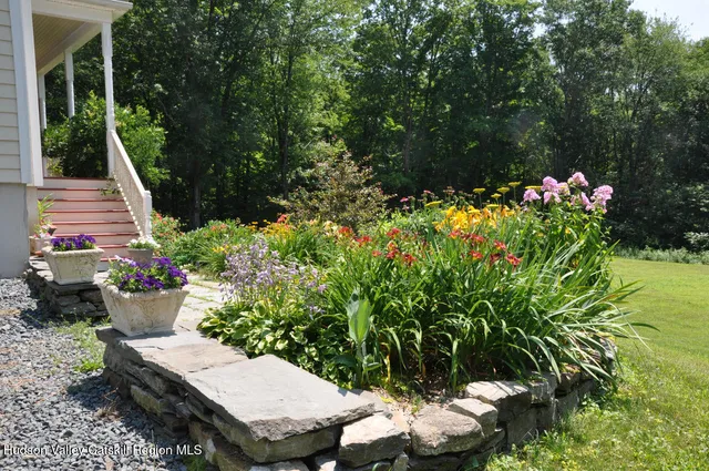 a wooden bench sitting in the middle of a garden