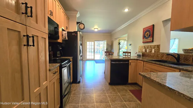 a kitchen with stainless steel appliances granite countertop a refrigerator and a sink