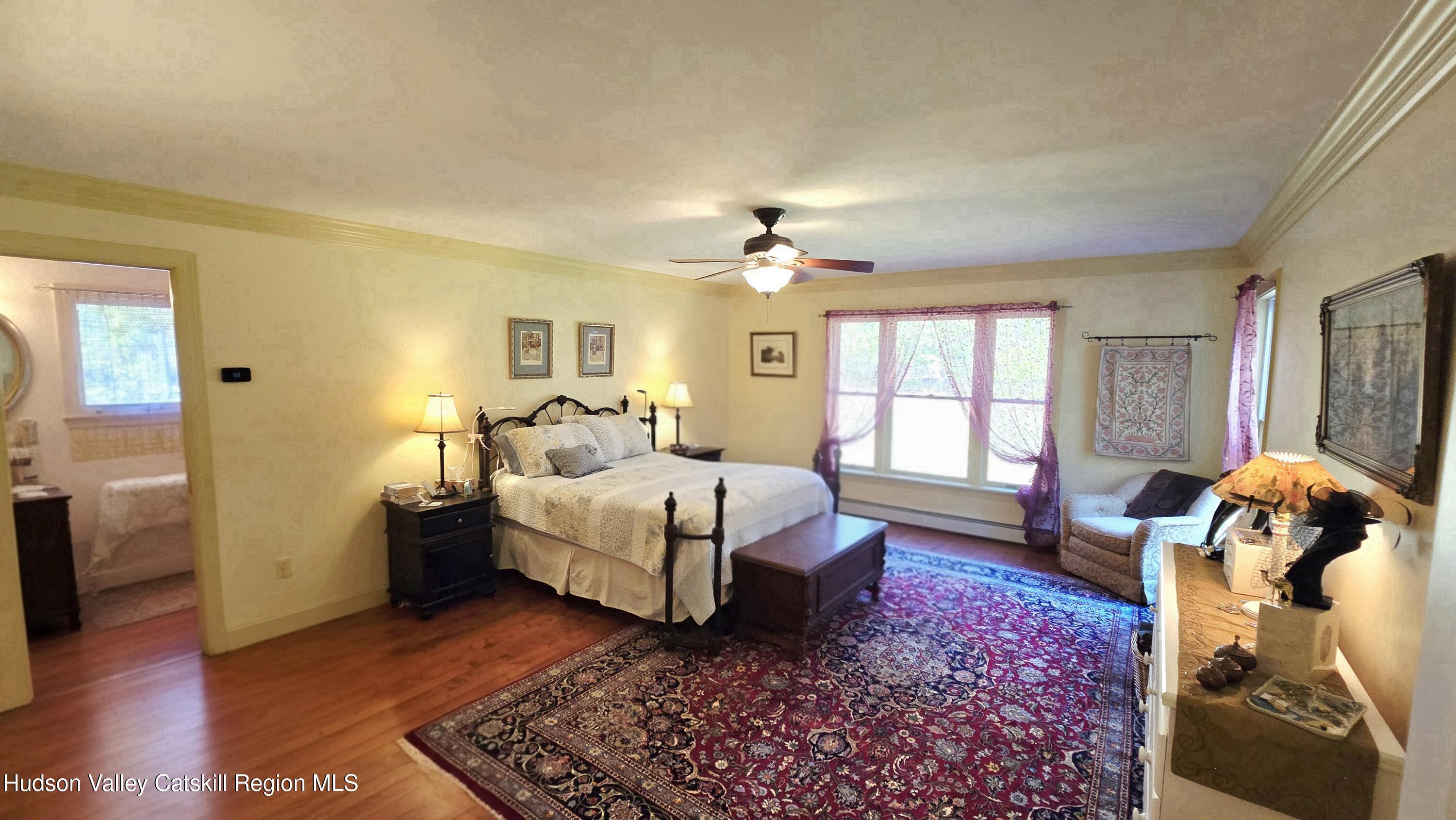3124-3100 County Rte 9 Canaan, NY 12060 - Photo 23 of 45 a spacious bedroom with a bed and wooden floor