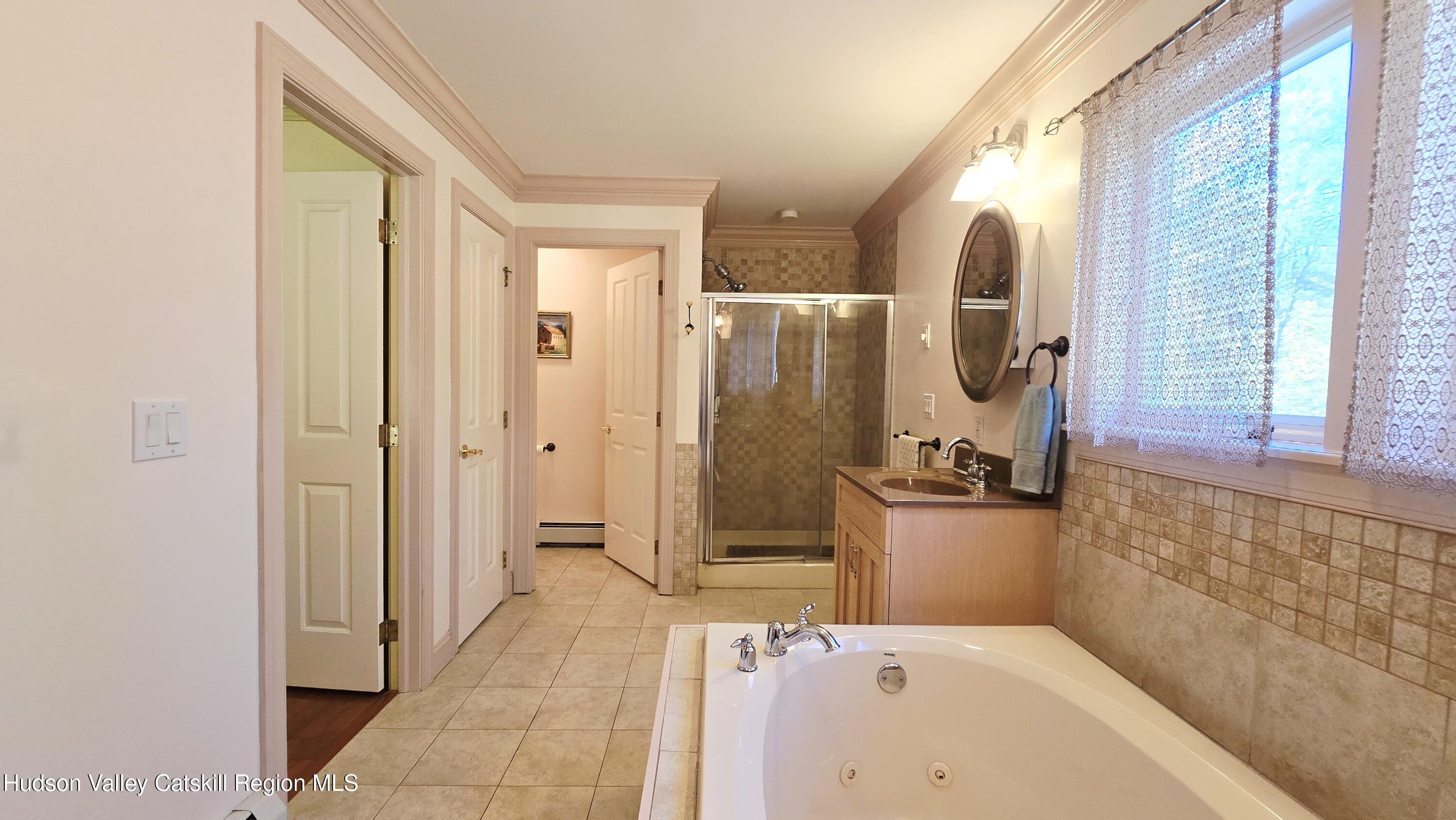 3124-3100 County Rte 9 Canaan, NY 12060 - Photo 25 of 45 a bathroom with a tub a sink and mirror