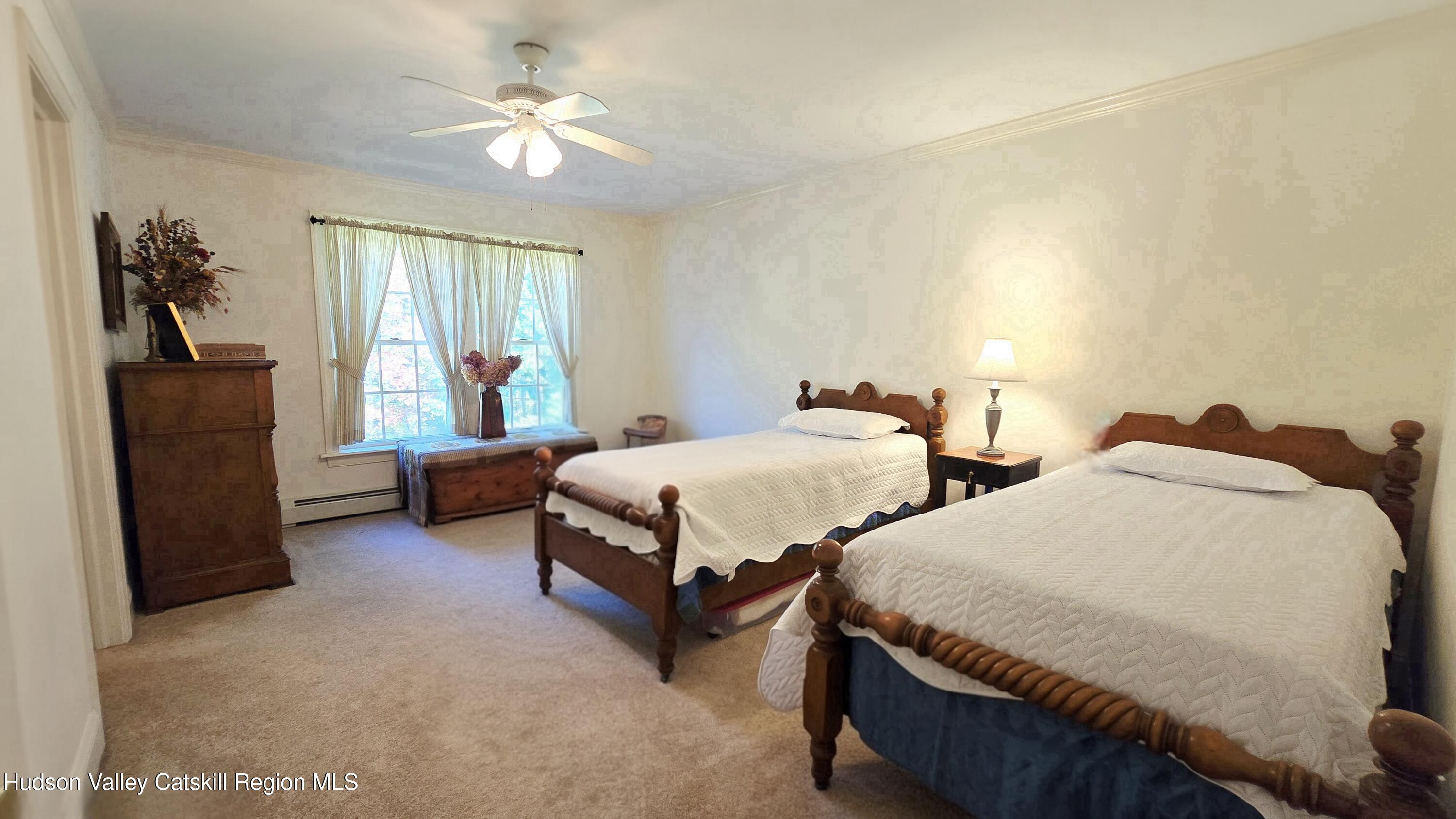 3124-3100 County Rte 9 Canaan, NY 12060 - Photo 33 of 45 a bedroom with two beds and a chandelier