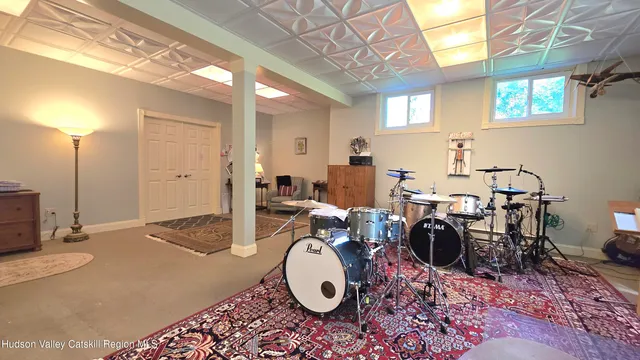 a living room with furniture a rug and a window