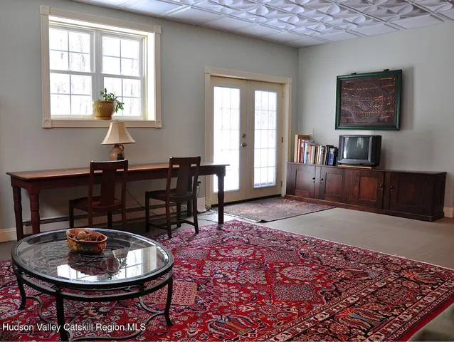 a bedroom with furniture and a window