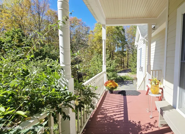 a view of a balcony with dining table and chairs