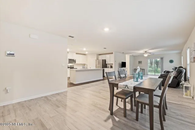 a view of a dining room with furniture and wooden floor