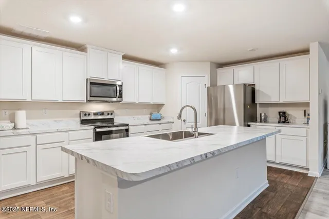 a kitchen with a sink a stove and refrigerator