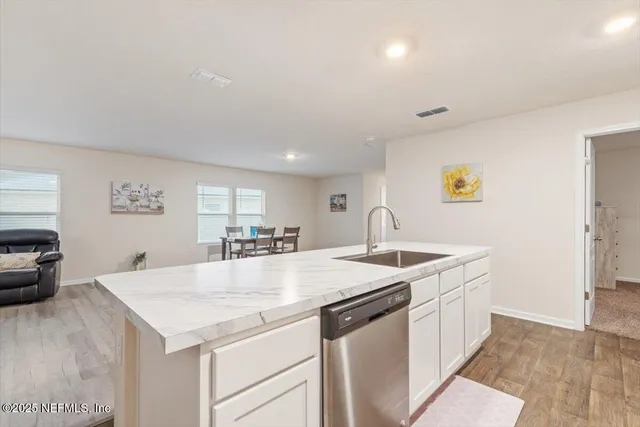a living room with furniture chandelier and a window