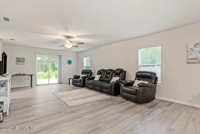 a large bedroom with a bed and a view of living room