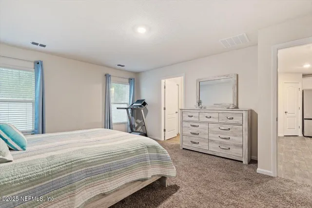 a en suite bathroom with a double vanity sink and a mirror