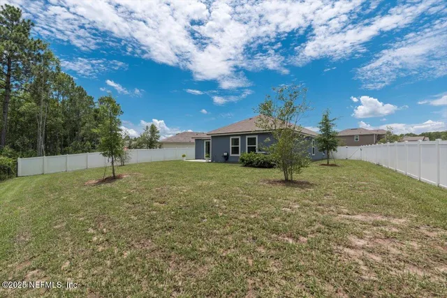 a backyard of a house with lots of green space