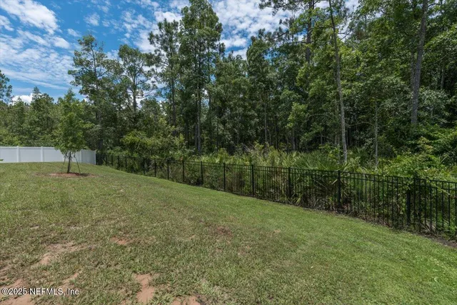 an aerial view of a house with garden space and lake view