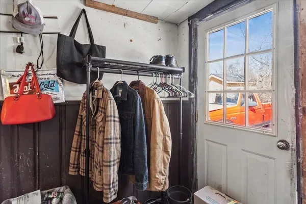 a view of walk in closet with clothes and shoes