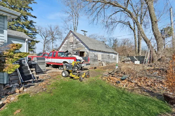 a view of a chairs and tables in the back yard of the house
