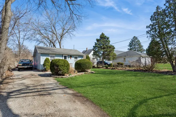 a view of a house with a yard and tree s
