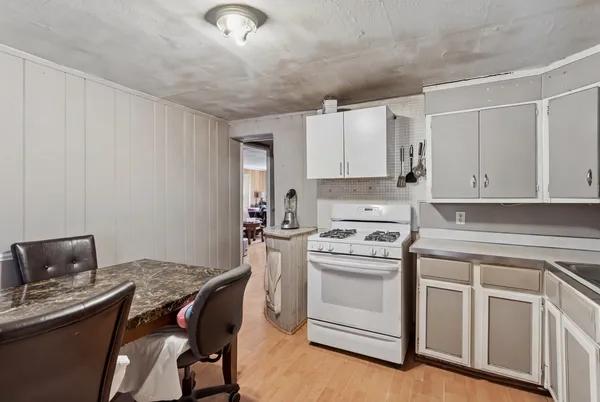 a kitchen with a stove a sink and a refrigerator