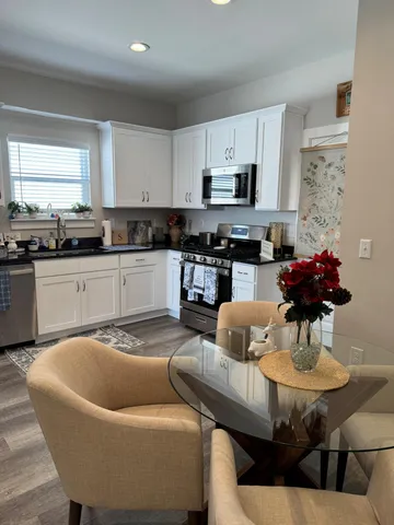 a kitchen with stainless steel appliances granite countertop a stove a sink and a refrigerator