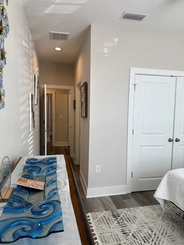 a bathroom with a granite countertop toilet sink and mirror