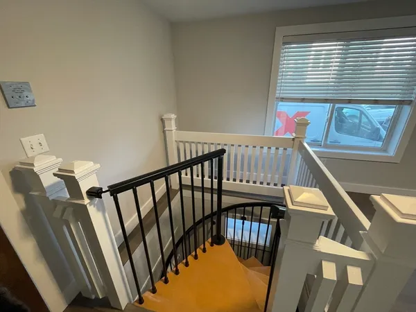 a view of entryway with wooden floor and stairs