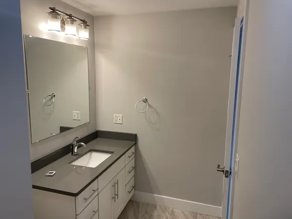 a white toilet sitting next to a bathroom sink