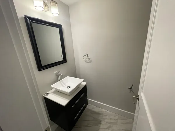 a white toilet sitting next to a white cabinet