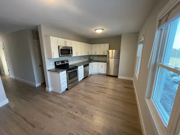 a kitchen with a refrigerator and a sink