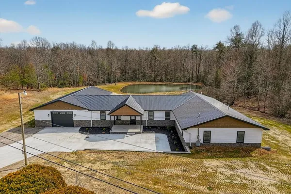 a view of a house with swimming pool and a yard