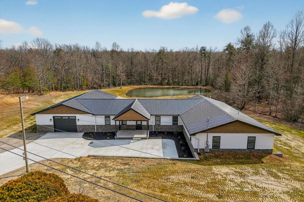 a view of a house with swimming pool and a yard