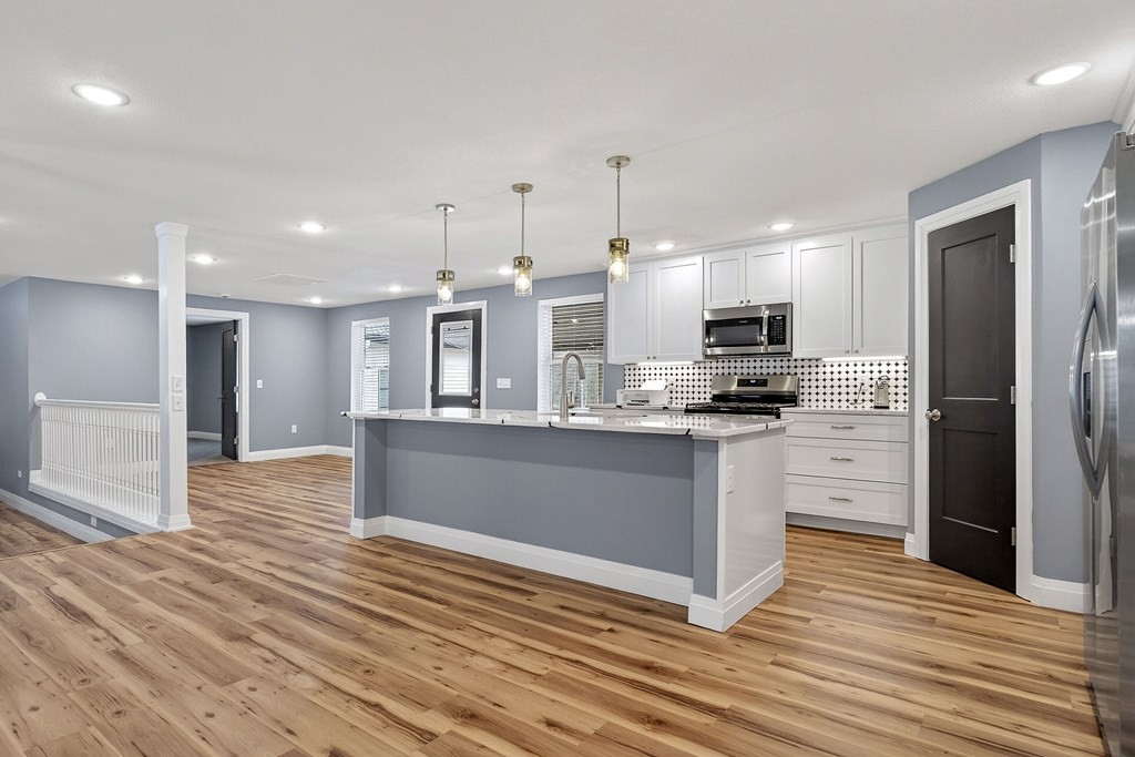 365 Spring Haven Lane Sparta, TN 38583 - Photo 18 of 60 a kitchen with stainless steel appliances kitchen island granite countertop a stove a refrigerator and a sink