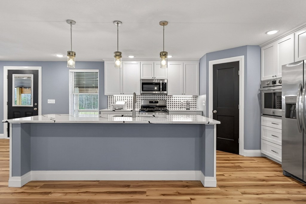 365 Spring Haven Lane Sparta, TN 38583 - Photo 19 of 60 a kitchen with stainless steel appliances granite countertop a refrigerator and a stove top oven