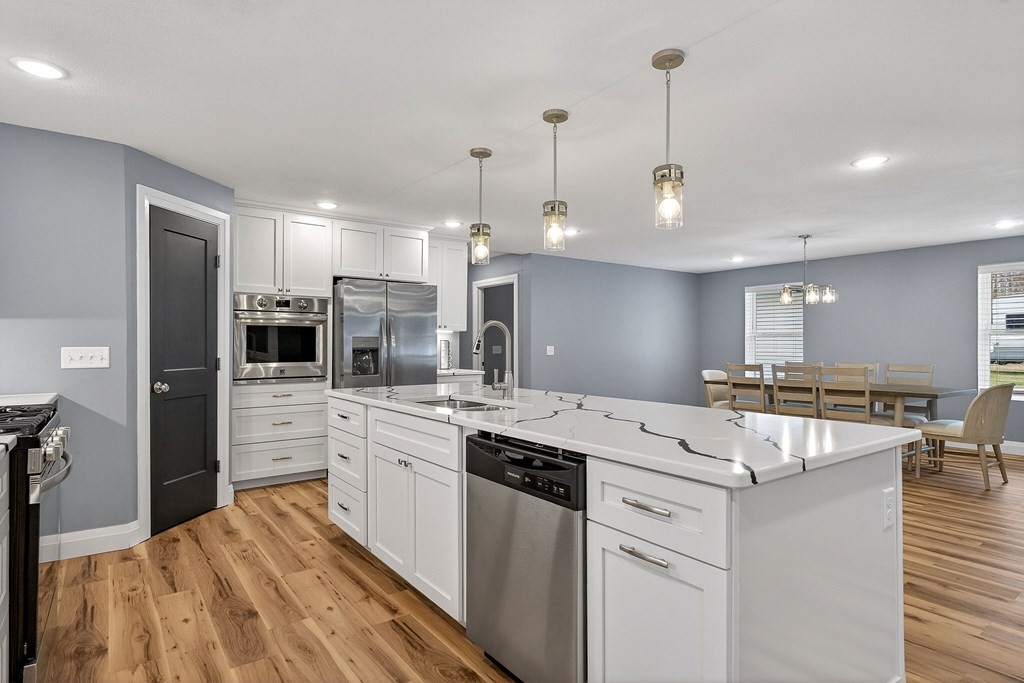 365 Spring Haven Lane Sparta, TN 38583 - Photo 20 of 60 a kitchen with a stove a sink a refrigerator and chairs