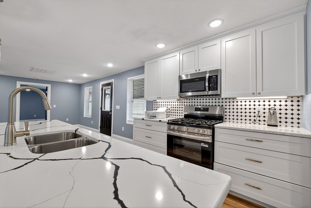 365 Spring Haven Lane Sparta, TN 38583 - Photo 22 of 60 a kitchen with granite countertop a sink cabinets and stainless steel appliances