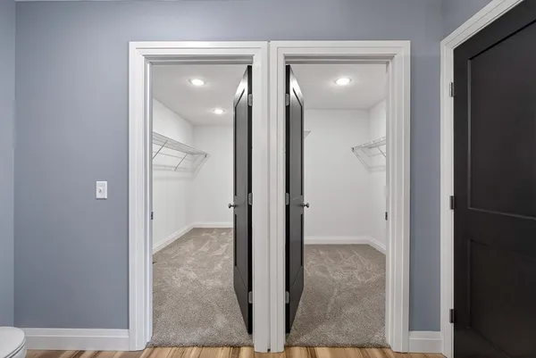 a view of room with wooden floor and fan