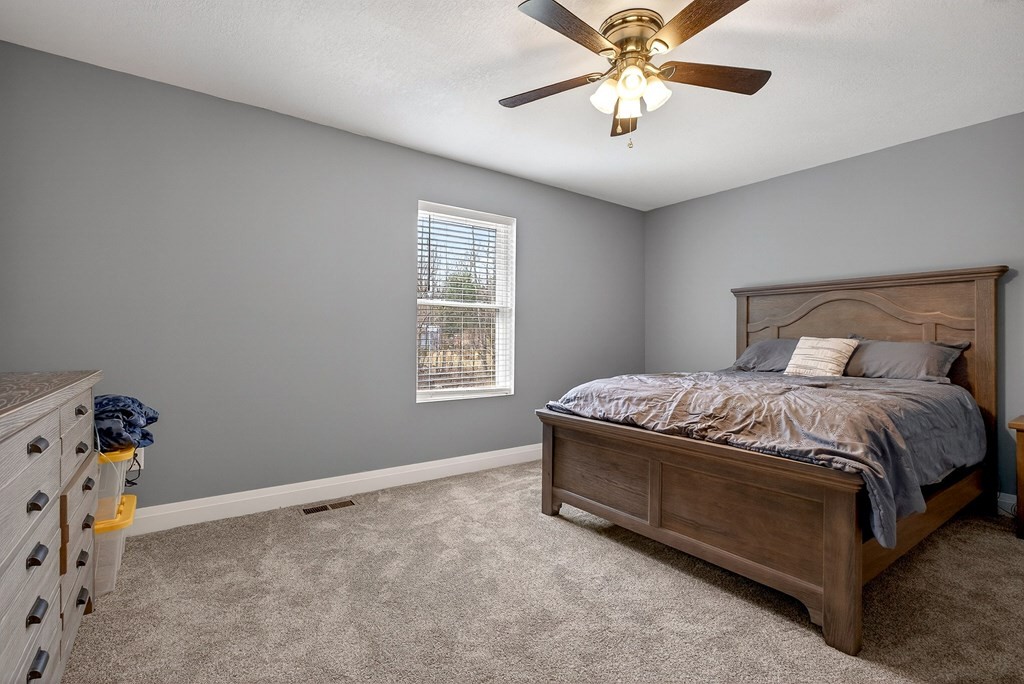 365 Spring Haven Lane Sparta, TN 38583 - Photo 35 of 60 a bedroom with a bed and a chandelier