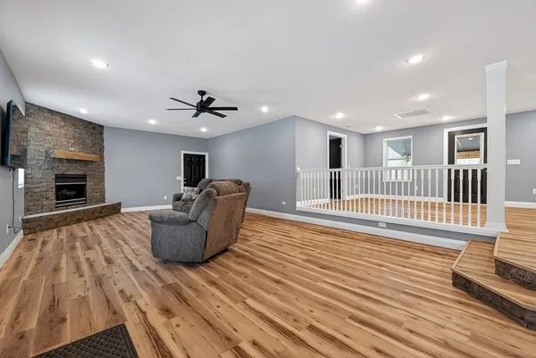 a view of livingroom with wooden floor and a fireplace