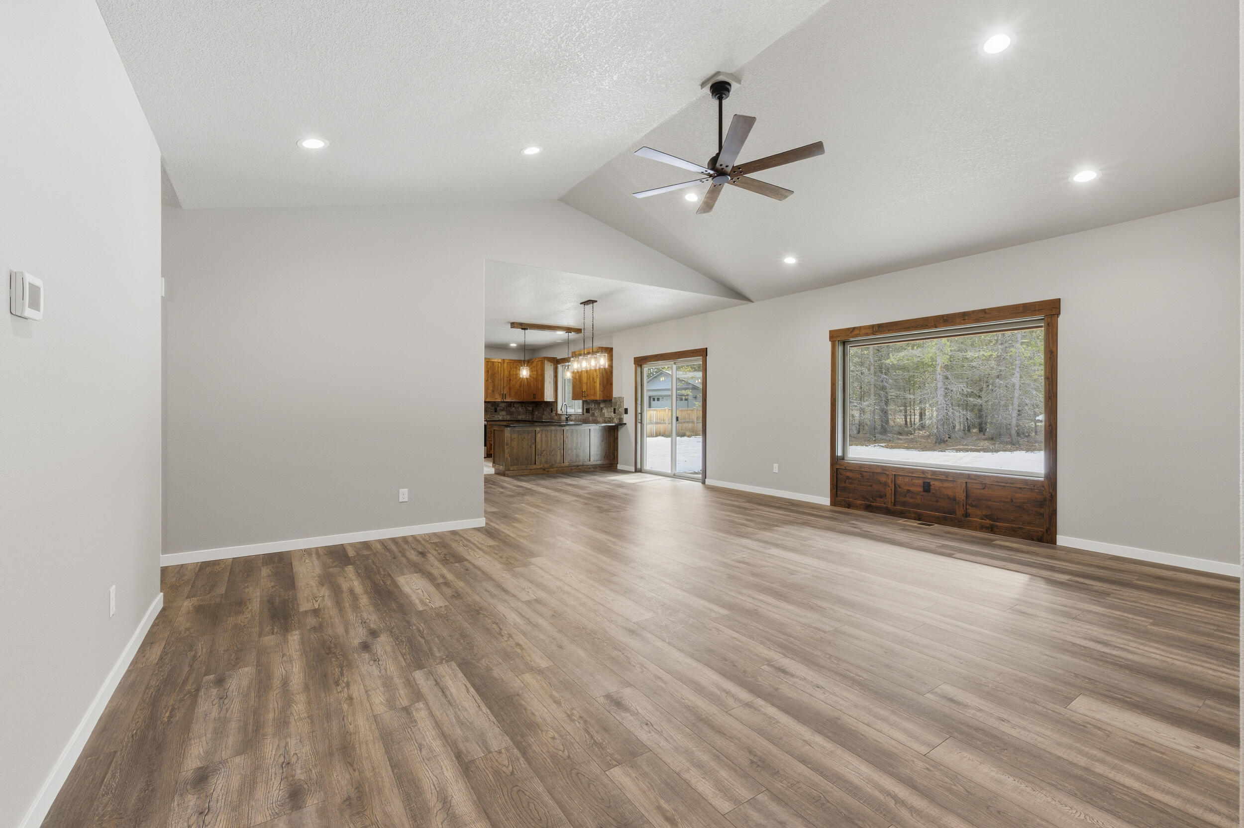16083 Dyke Road, Unit 9 La Pine, OR 97739 - Photo 6 of 53 a view of an empty room with a window and wooden floor