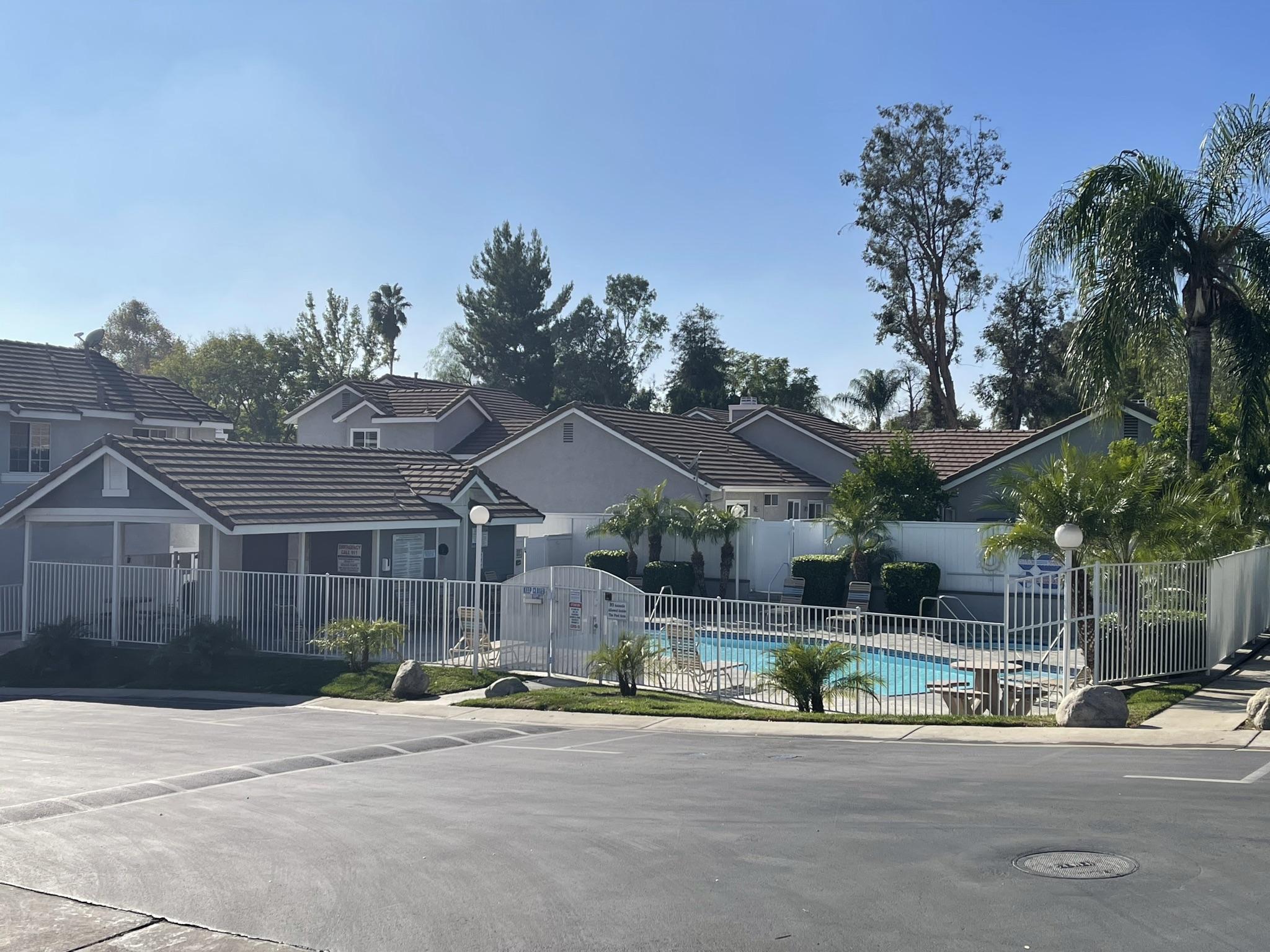 a view of a house with a yard and potted plants