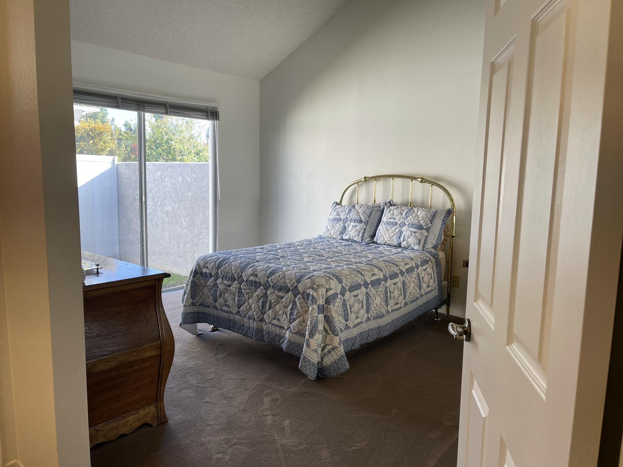 9661 Northampton Drive Rancho Cucamonga, CA 91737 - Photo 14 of 27 a bedroom with a bed lamp and a window