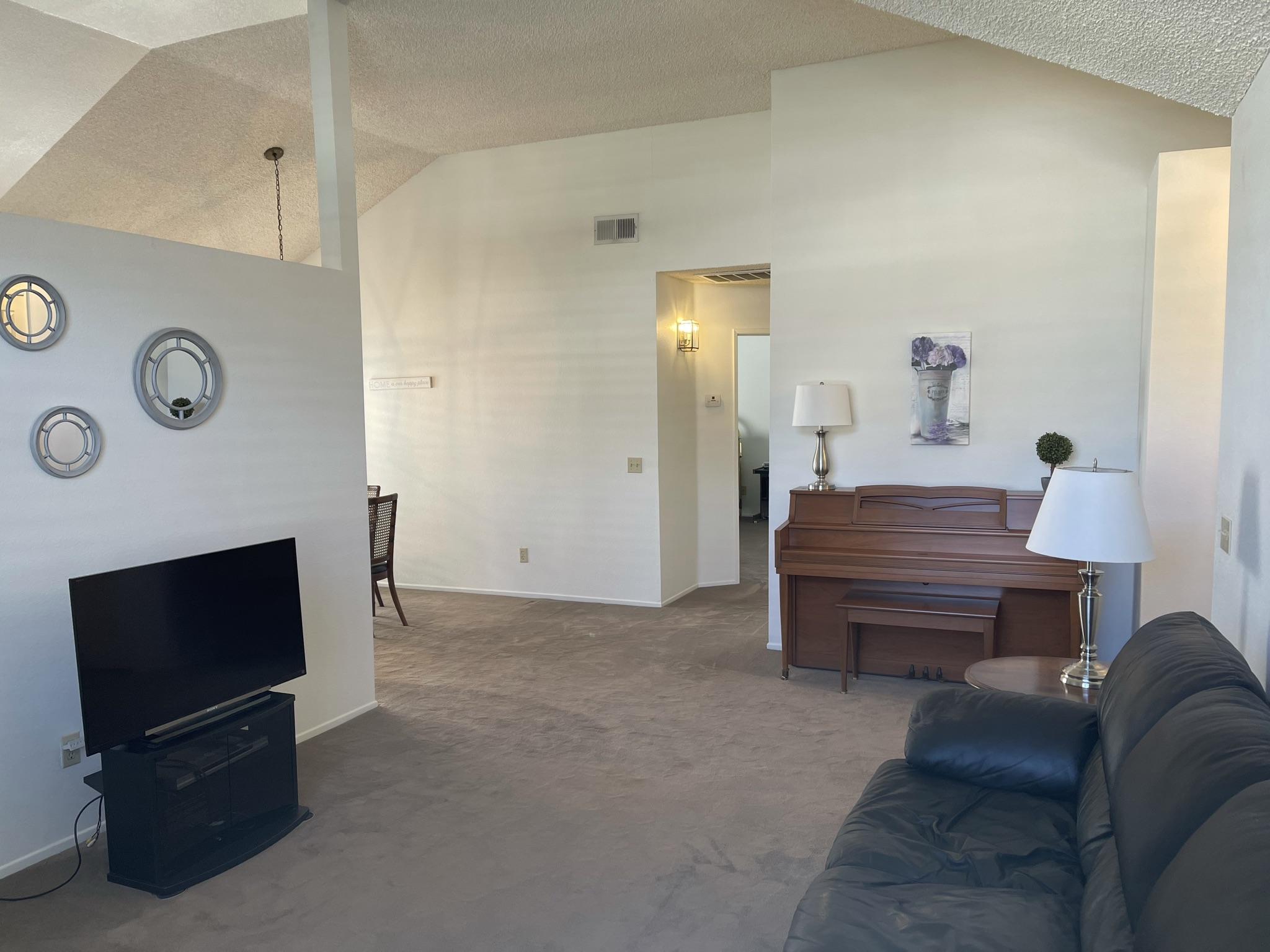 9661 Northampton Drive Rancho Cucamonga, CA 91737 - Photo 26 of 27 a living room with furniture and a flat screen tv