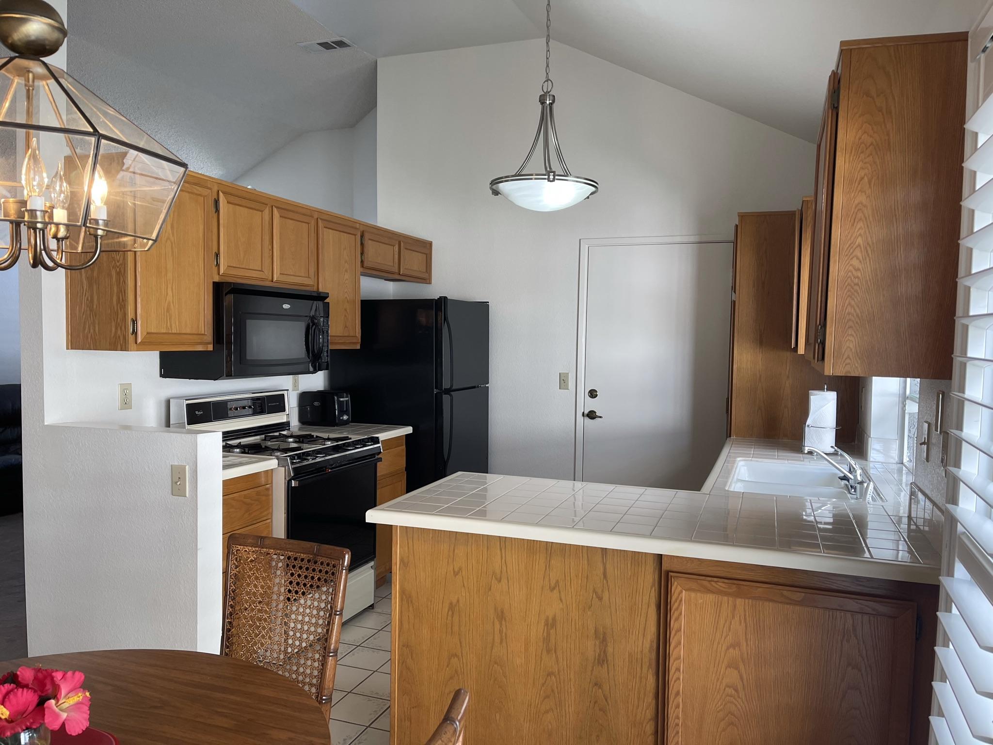 9661 Northampton Drive Rancho Cucamonga, CA 91737 - Photo 9 of 27 a kitchen with stainless steel appliances a refrigerator and a stove top oven