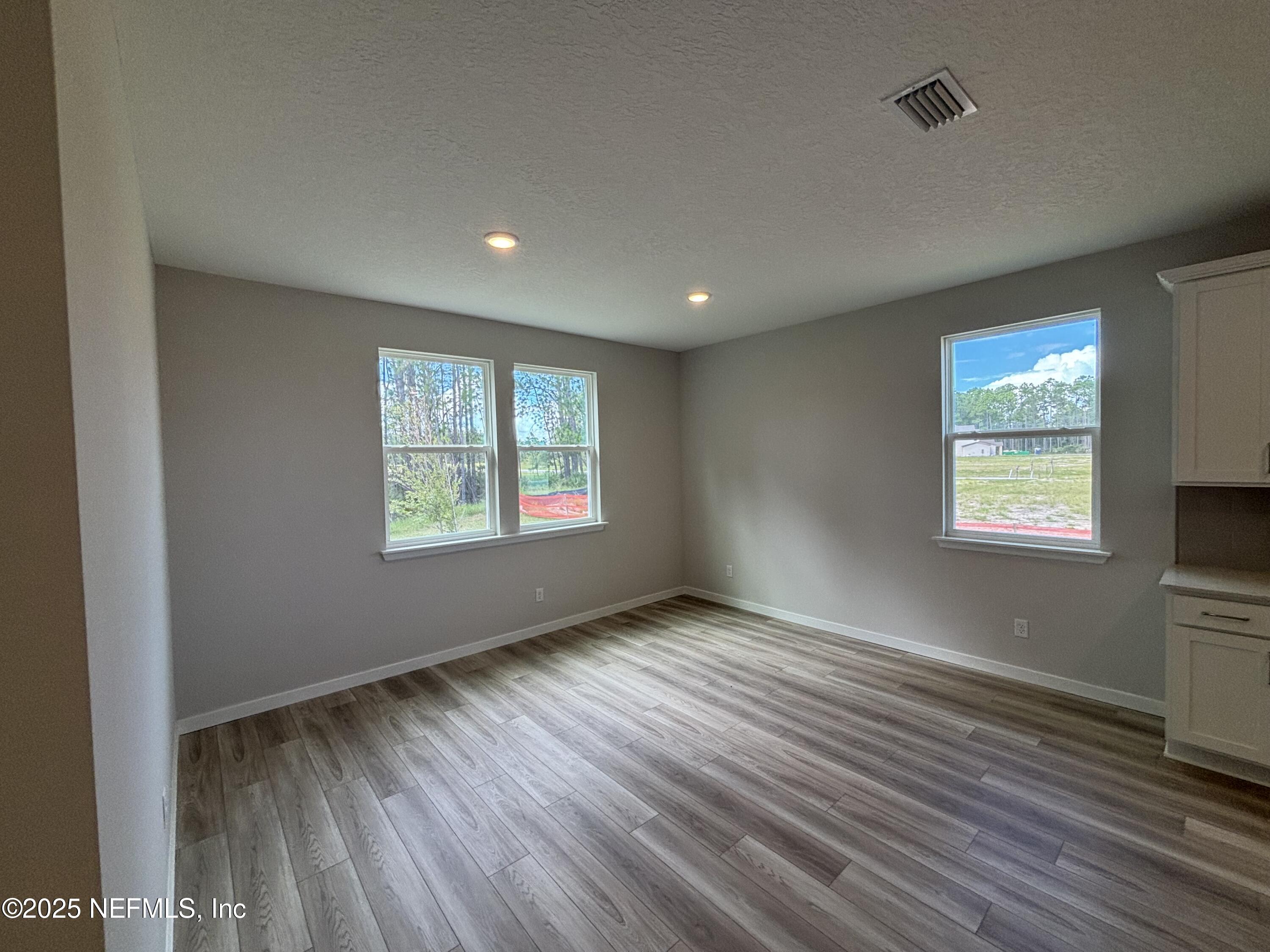 71 Pegasus Road Flagler Beach, FL 32136 - Photo 15 of 25 an empty room with wooden floor and windows