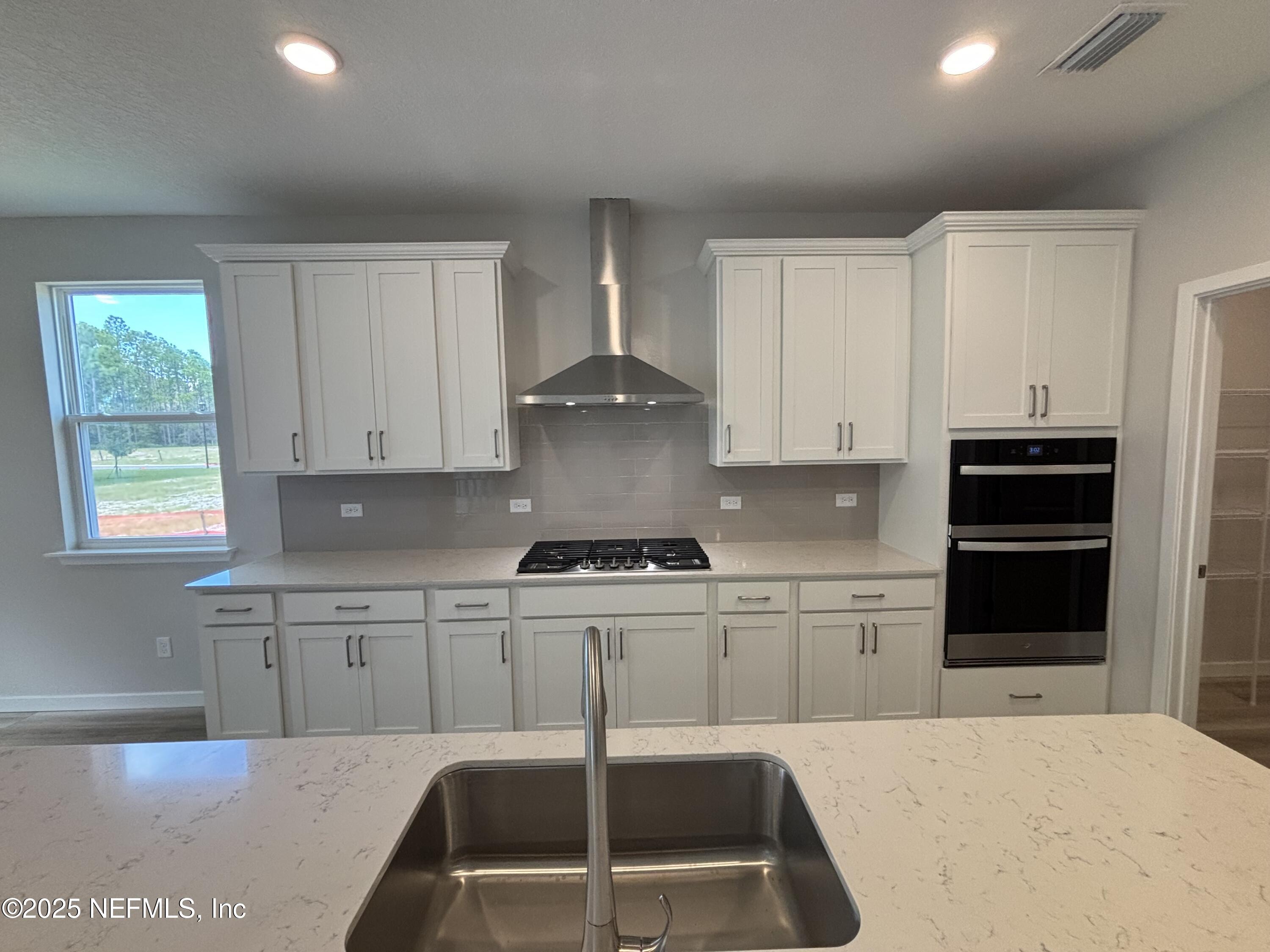71 Pegasus Road Flagler Beach, FL 32136 - Photo 18 of 25 a kitchen with a stove a sink and a refrigerator