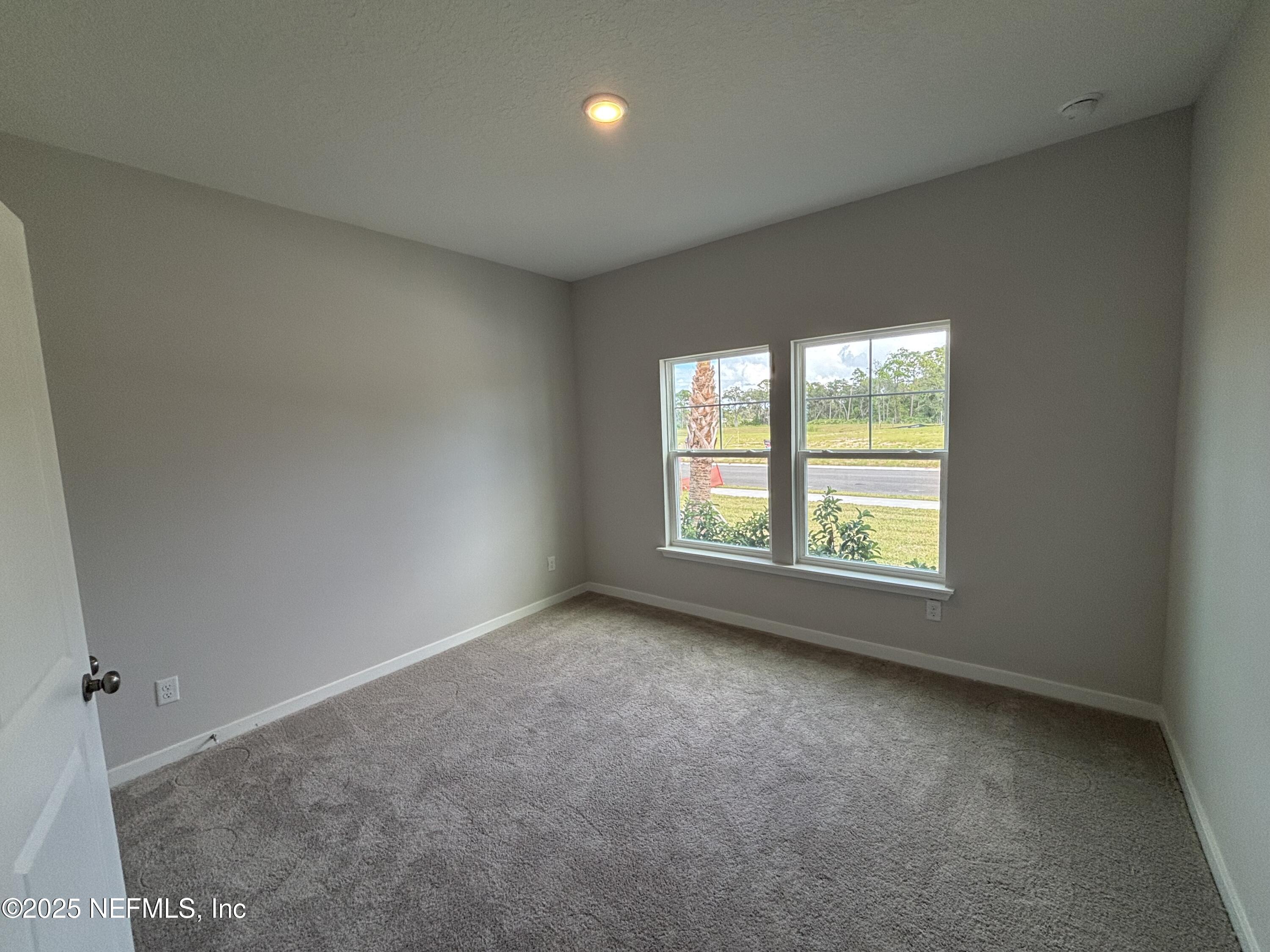 71 Pegasus Road Flagler Beach, FL 32136 - Photo 5 of 25 an empty room with a window