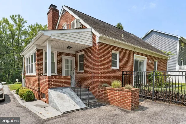 a view of a brick house with large windows